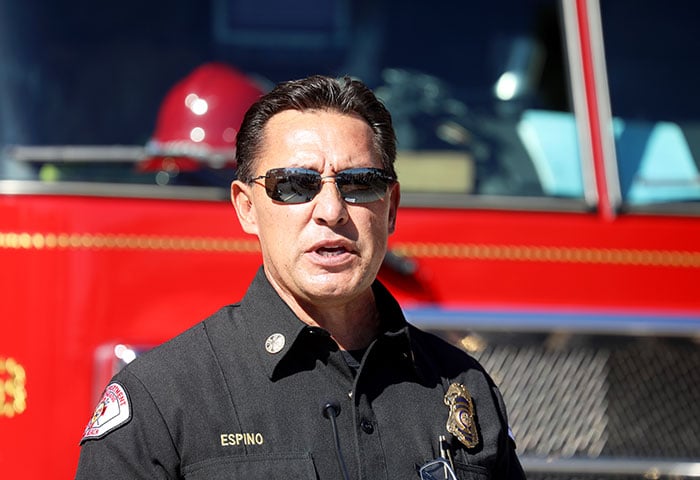 Hình ảnh một lính cứu hỏa đeo kính, trước xe cứu hỏa.
